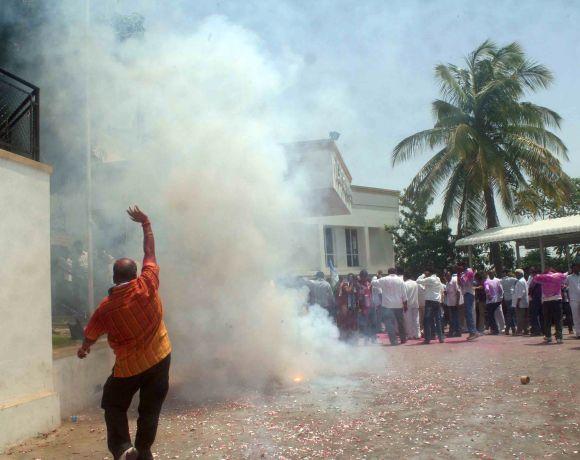 Supporters of YSR Congress chief Jaganmohan Reddy celebrate his party's victory