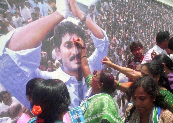 Women activists celebrate the victory of YSR Congress in the AP by-poll