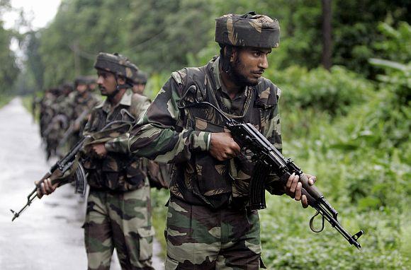 Indian Army soldiers patrol in the forests of Manabhum along the Burma border