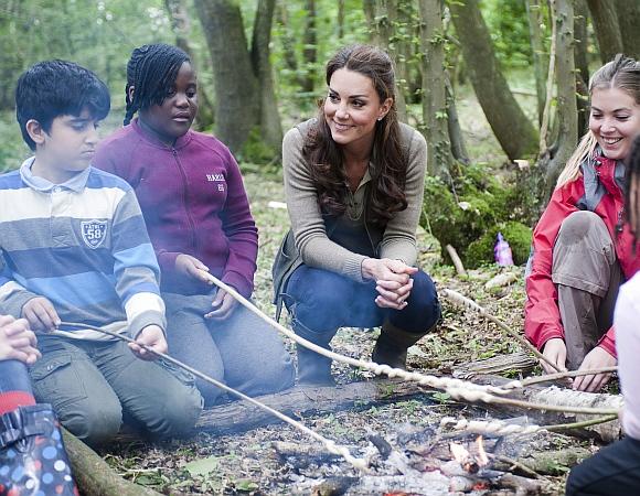 Britain's Catherine, Duchess of Cambridge speaks to children during a visit to the 'Expanding Horizons' Primary School Project in Wrotham, southern England