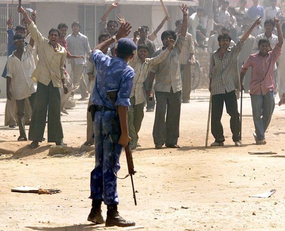 An RAF trooper confronts rioters during the Gujarat riots in 2002. Photograph: Arko Datta/Reuters