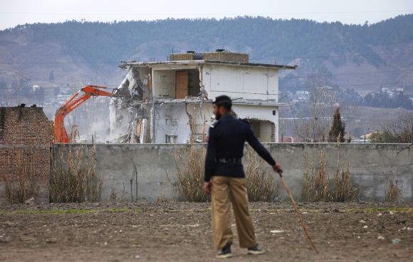 A policeman looks on as the building where bin Laden was killed is demolished in Abbottabad