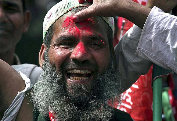 SP workers celebrate their victory in the UP polls