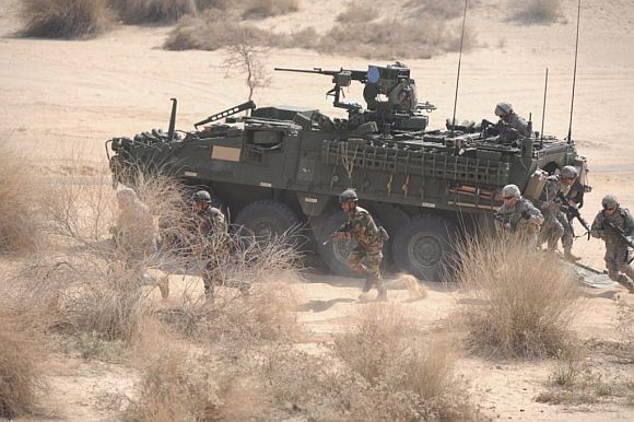 Indian and US troops exit the Stryker armoured fighting vehicle