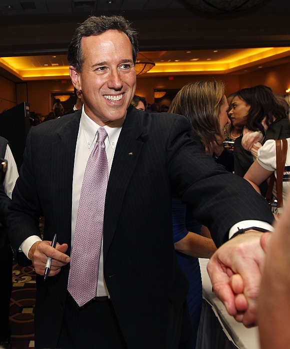 Republican United States presidential candidate and former senator Rick Santorum shakes hands with supporters after speaking at his Alabama and Mississippi primary election night rally in Lafayette, Louisiana