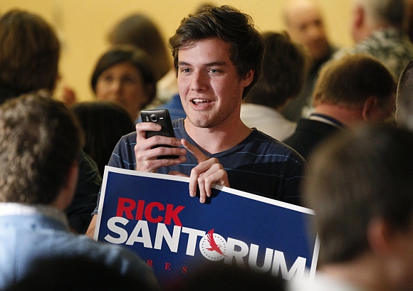Supporters of Santorum wait for results at Santorum's Alabama and Mississippi primary election night rally in Lafayette