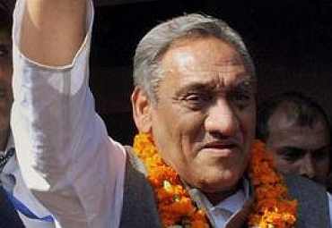 Bahuguna waves to his supporters after his swearing-in ceremony