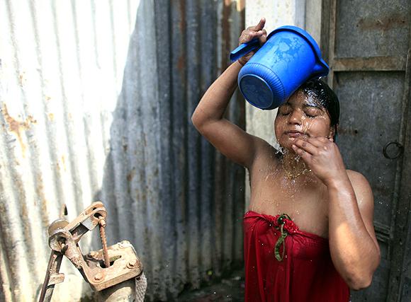 Hashi washes her hair at Kandapara brothel in Tangail