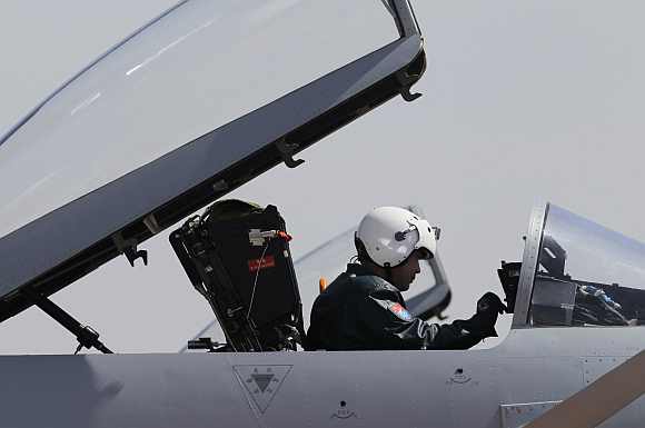 A pilot sits in the cockpit of a J-10 fighter jet