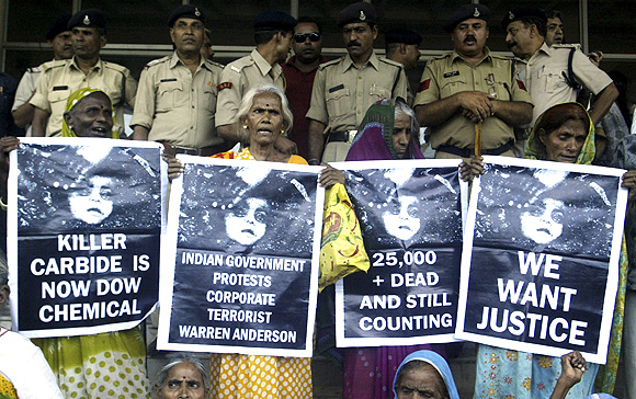 Victims of Bhopal gas tragedy hold posters during a demonstration