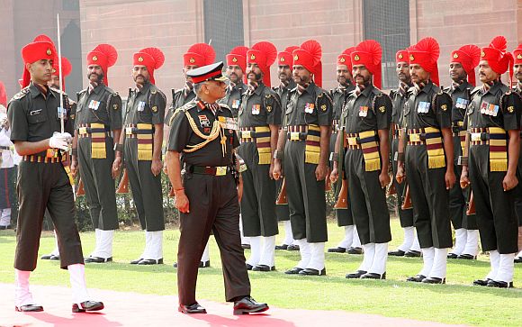 File photo shows General Singh inspecting a guard of honour