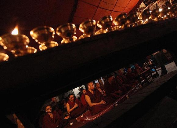 Tibetan monks attend a memorial prayer meeting for Jamphel Yeshi, who lost his life after setting himself on fire on Monday during a protest against the upcoming visit of Chinese President Hu Jintao to India, at Majnu Ka Tila