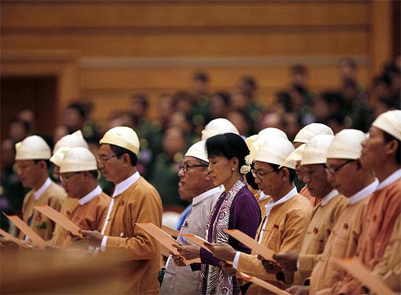 Myanmar pro-democracy leader Aung San Suu Kyi and members of parliament from the National League for Democracy take their oaths in the lower house of parliament in Naypyitaw