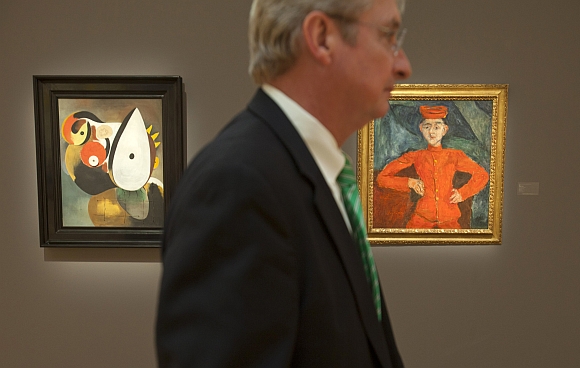 A worker stands beside Joan Miro