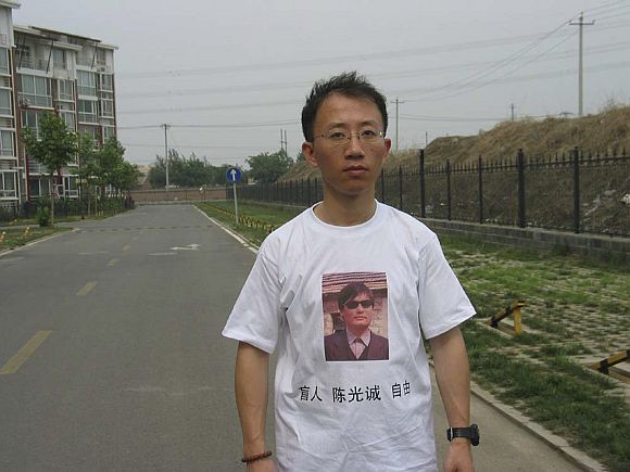 One of China's most prominent dissidents, Hu Jia, wears a shirt in support of blind Chinese lawyer Chen Guangcheng, in this undated handout