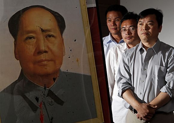 On June 2, 2009, three Chinese dissidents, from left to right, Yu Zhijian, Yu Dongyue and Lu Decheng pose beside a photograph of the defaced Chairman Mao portrait, which they had pelted with dye-filled eggs during the 1989 Tiananmen Square democracy movement