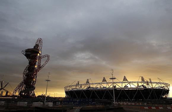 The sun sets behind the Olympic stadium and Anish Kapoor's ArcelorMittal Orbit tower in Stratford, east London