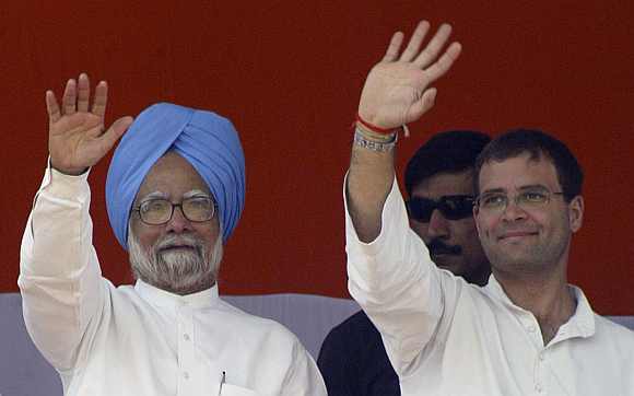Prime Minister Manmohan Singh and Rahul Gandhi wave to supporters