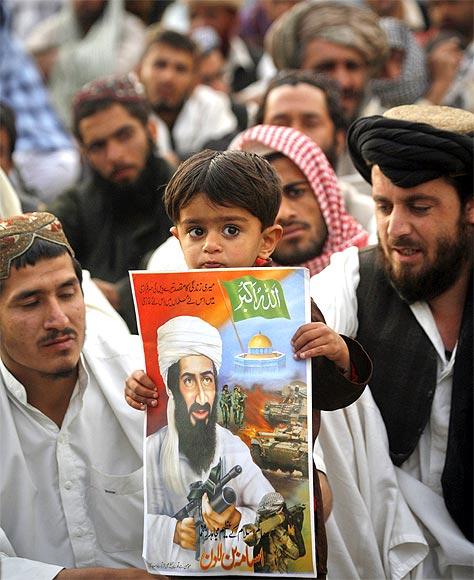 A child holds an image of Al Qaeda leader Osama bin Laden during an anti-American rally