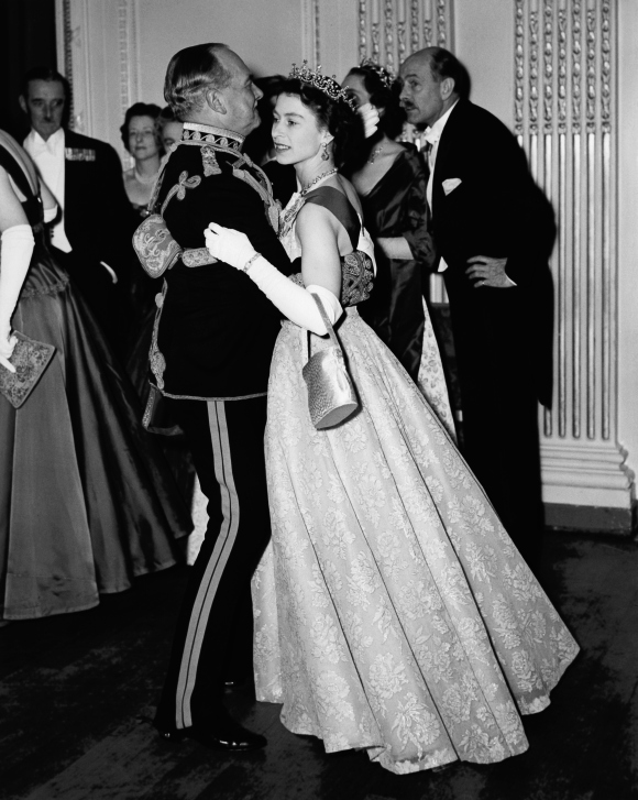 Queen Elizabeth II dancing with Air Marshal Sir John Baldwin (1892 - 1975), colonel of the 8th Hussars, at a ball held at the Hyde Park Hotel, London. The ball celebrates the centenary of the Battle of Balaclava. Photo taken on November 26, 1954