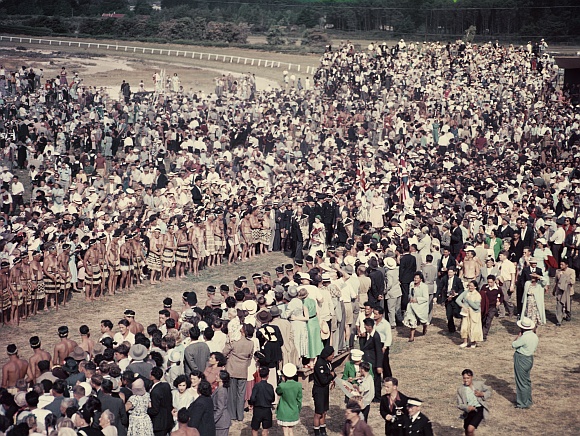 Queen Elizabeth II and Prince Philip walk through the crowd at Arawa Park, Rotorua, during her Commonwealth visit to New Zealand. She was met by around 20,000 Maoris from all over the country. Photo taken in January 1954