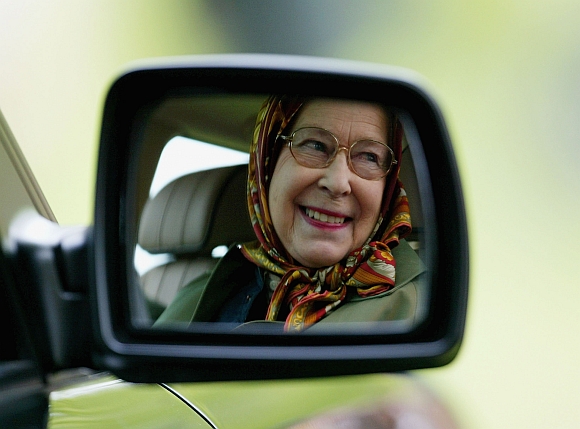 Queen Elizabeth II is seen reflected in the wing mirror of her Land Rover as she follows The Duke of Edinburgh as he competes in the Driving Grand Prix Competition B -- the marathon event during the Royal Windsor Horse Show at Home Park, Windsor Castle in Windsor, England. Photo taken on 14 May, 2005
