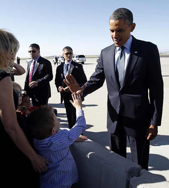 Obama gives a boy a high five upon his arrival in Colorado Springs, Colorado on May 23