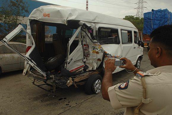 A policeman takes photos of the accident site