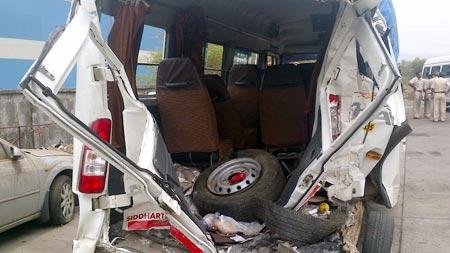 The mangled remains of the tourist minibus, which was hit by a speeding truck on the Mumbai-Pune Expressway