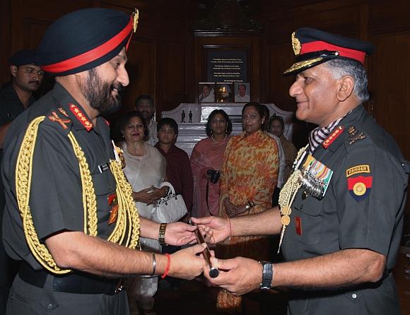 Outgoing army chief General V K Singh hands over the baton to General Bikram Singh