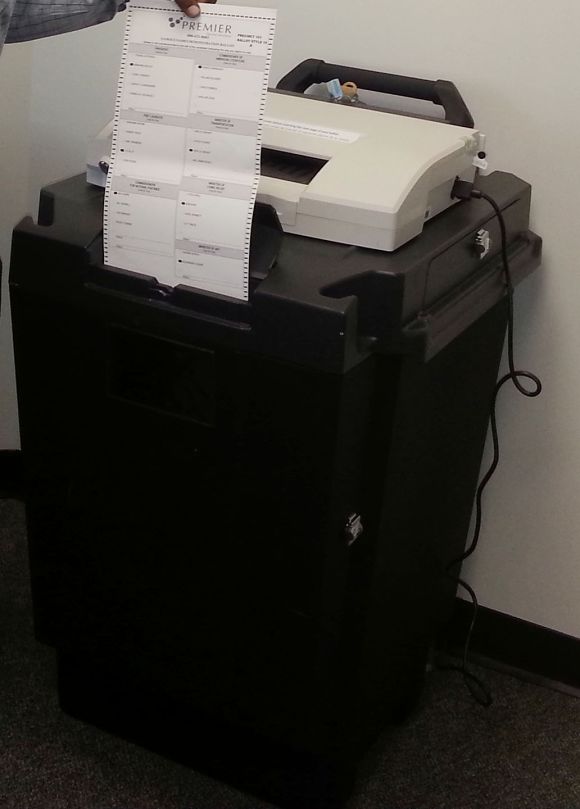 A completed ballot paper goes through the scanner. Once the document is scanned, the Election Zero Report -- a confirmation that a candidate's vote has been registered -- comes out from the top left of the machine