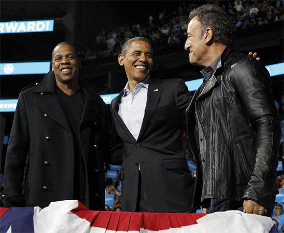 US President Barack Obama with rapper Jay-Z and musician Bruce Springsteen at an election campaign rally