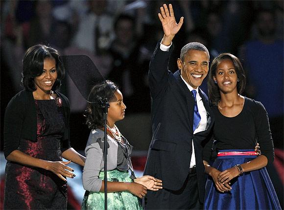 Obama waves with his daughters Malia and Sasha and wife Michelle during his election night victory rally in Chicago