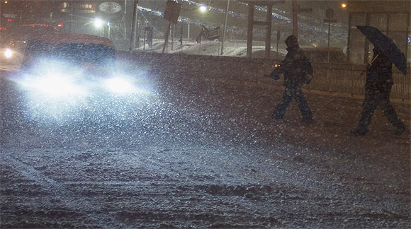 Pedestrians walk through a snow storm in the Staten Island borough of New York