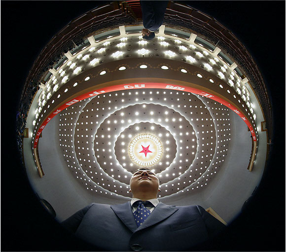 A security officer stands guard after China's President Hu Jintao's speech at the opening ceremony of 18th National Congress of the Communist Party of China