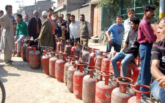 People wait in queue to get their LPG cylinders refilled