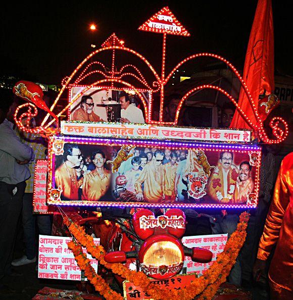 The customised bike sporting the Sena logo and its leadership outside Matoshree