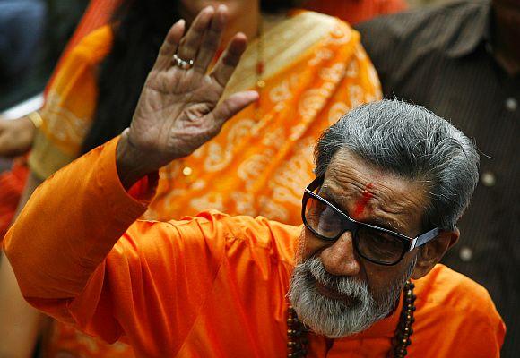 Thackeray, chief of Shiv Sena, waves towards the media as he arrives to cast his vote at a polling centre in Mumbai