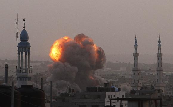 An explosion and smoke are seen after Israeli air strikes in Gaza