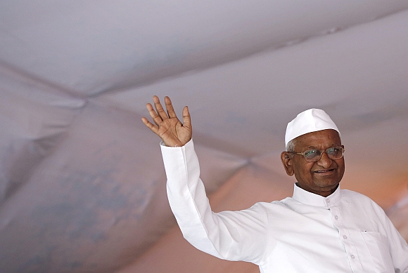 Anna Hazare waves to his supporters during his public hunger strike in New Delhi