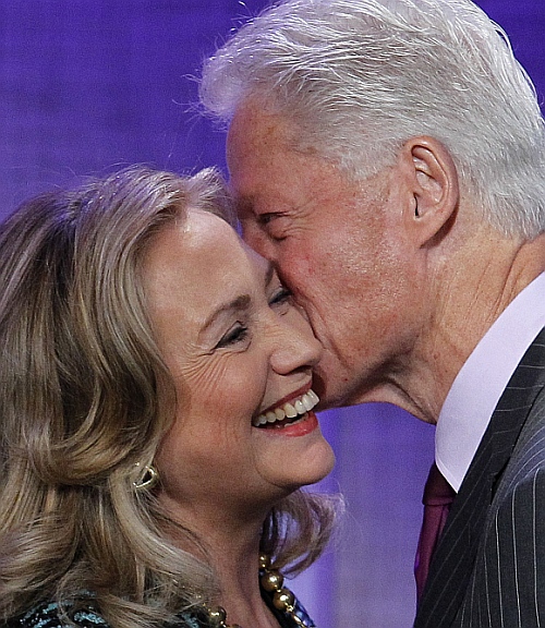 Former US President Bill Clinton kisses his wife, US Secretary of State Hillary Clinton, as he introduces her before her speech at the Clinton Global Initiative 2012 in New York