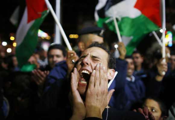 A Palestinian man shouts slogans during a rally in the West Bank city of Ramallah. The 193-nation UN General Assembly overwhelmingly approved a resolution on Thursday to upgrade the Palestinian Authority's observer status at the United Nations from entity to non-member state, implicitly recognising a Palestinian state