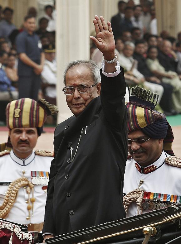 President Pranab Mukherjee waves from a horse carriage after his swearing-in ceremony, at Rashtrapati Bhavan in New Delhi