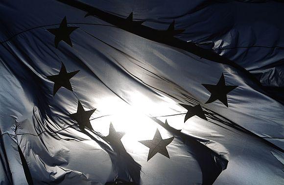 The EU flag is pictured atop the Reichstag building in Berlin on Friday