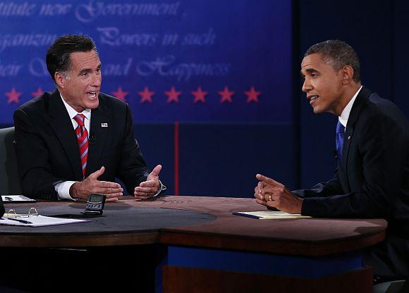 US President Barack Obama debates with Republican presidential candidate Mitt Romney as moderator Bob Schieffer listens at the Keith C and Elaine Johnson Wold Performing Arts Centre at Lynn University