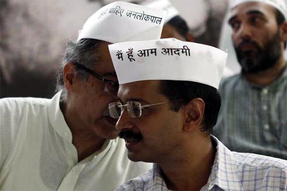 Arvind Kejriwal and fellow activist Prashant Bhushan, left, partly seen