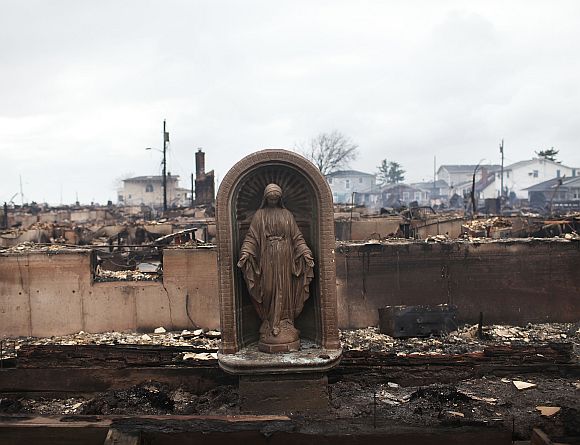 A Virgin Mary is all that remains from a home which was destroyed during Hurricane Sandy in Breezy Point, Queens