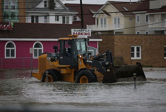 A loader moves sand washed in from Hurricane Sandy in Ocean City, New Jersey