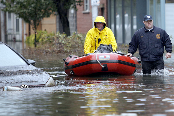 -Rescue workers patrol a flooded street at Hoboken in New Jersey