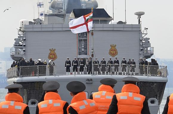 Russian sailors look on as the Indian navy's INS Delhi arrives in Russia's far eastern port of Vladivostok